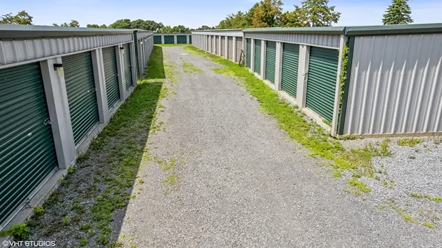 Outdoor storage units with gravel road.