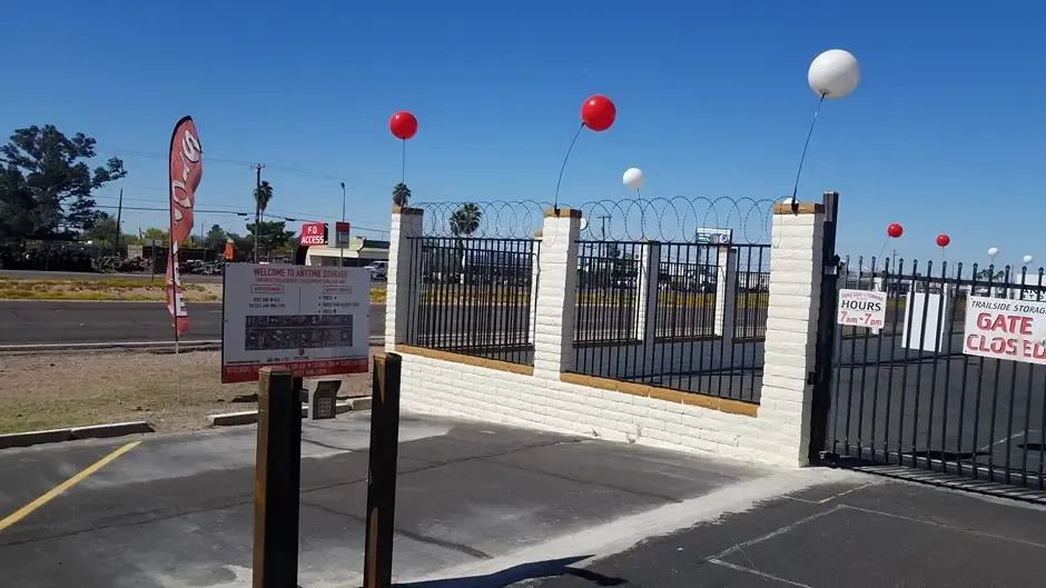 entrance of a storage facility with closed gate and a keypad