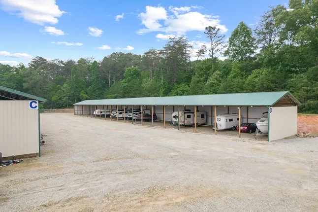 Gravel lot with covered vehicle parking.