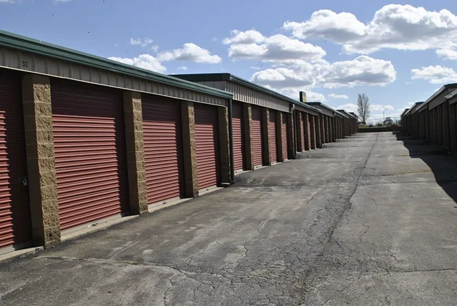 Storage units outside with paved ground.