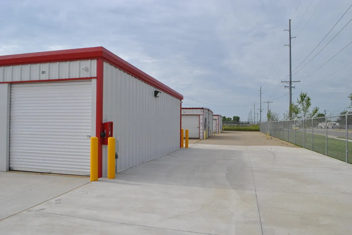 End of storage units row with hire extinguisher.