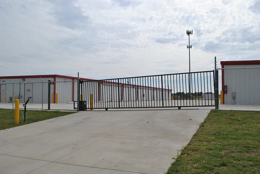 Front entrance of storage facility with gate and keypad.