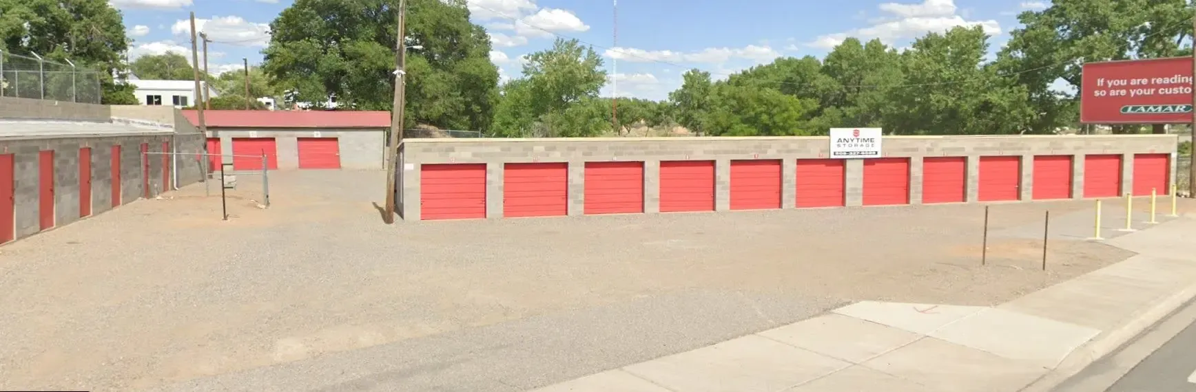 view of an open storage facility with drive up units and a gravel drive way