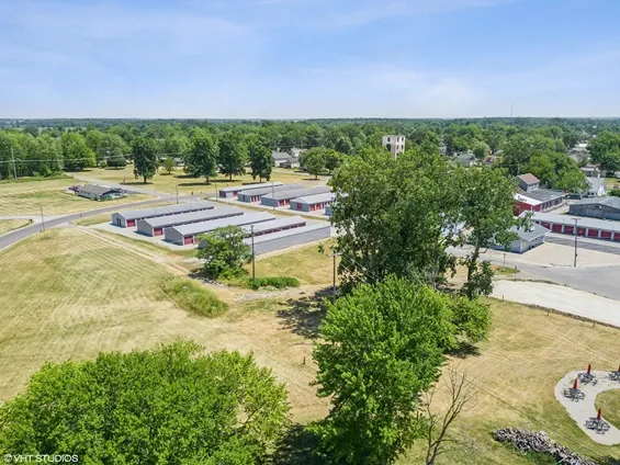 Aerial view of storage facility with a big tree in front.